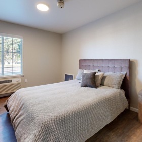 a bedroom with a bed and a window