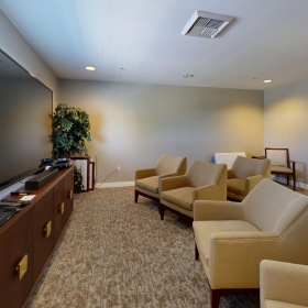 a room with a tv and chairs